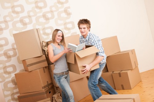 Professional piano movers handling a grand piano relocation in South West London